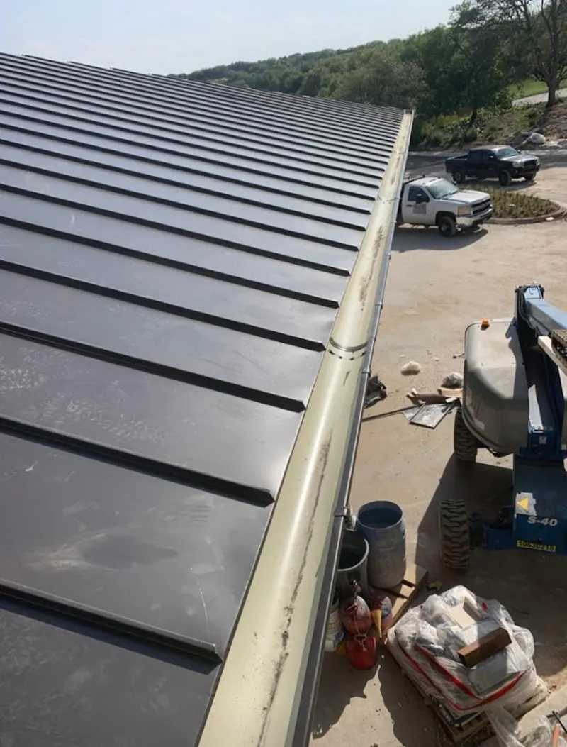 Standing seam panel and gutter detail on a metal roofing jobsite in Chester